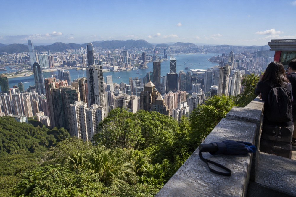 View over dense Hong Kong skyscrapers and the harbour from a high vantage point at the Peak