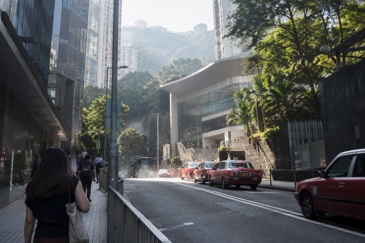 Garden Road rising uphill toward the Peak Tram lower terminus building among Hong Kong skyscrapers