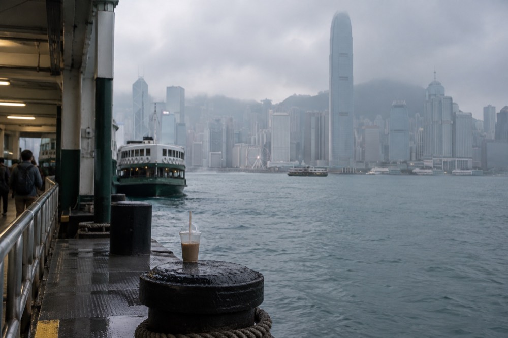 City skyline rising into low cloud above the harbour on a hazy morning
