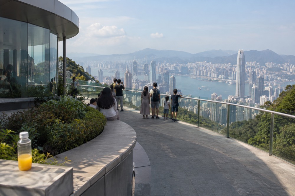 A rooftop viewing deck overlooking Victoria Harbour and the Hong Kong skyline