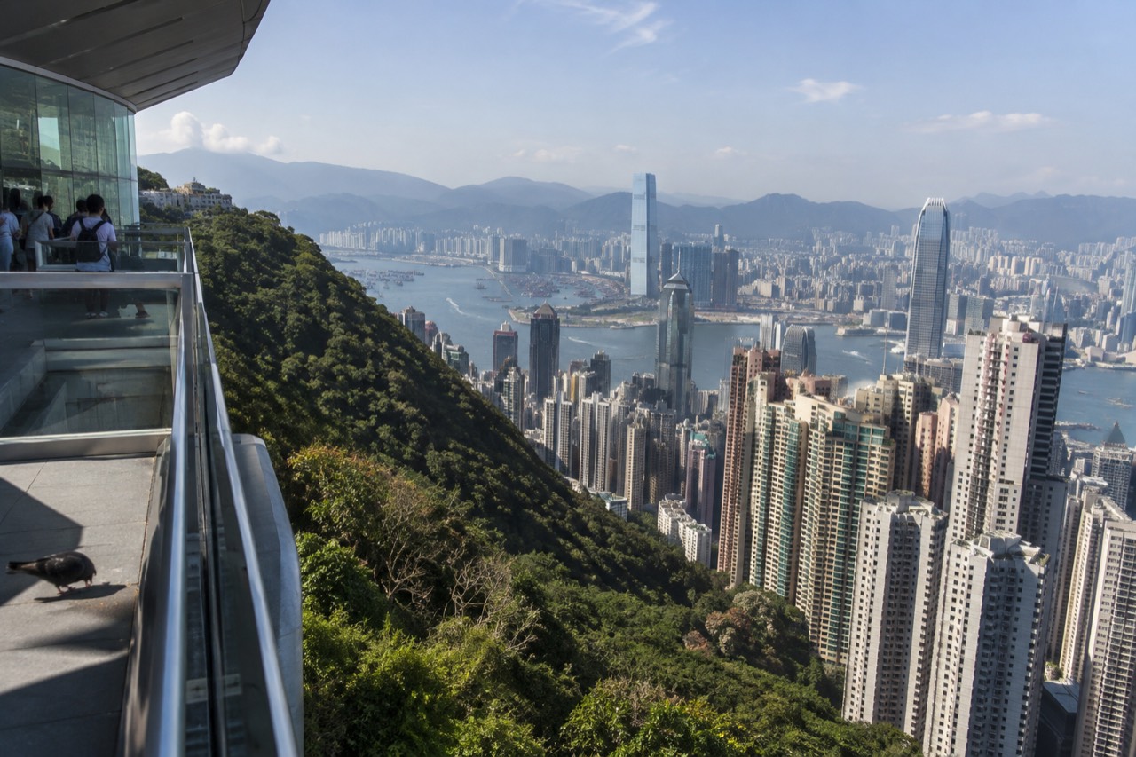 View across the rooftops and towers of the Peak area toward Victoria Harbour on a clear afternoon