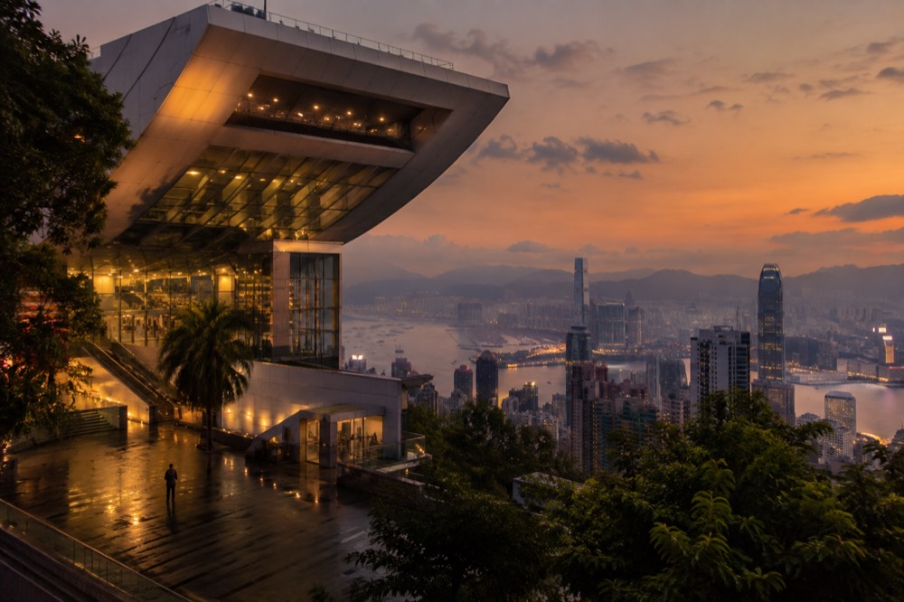 The Peak Tower building lit against an evening sky above Hong Kong