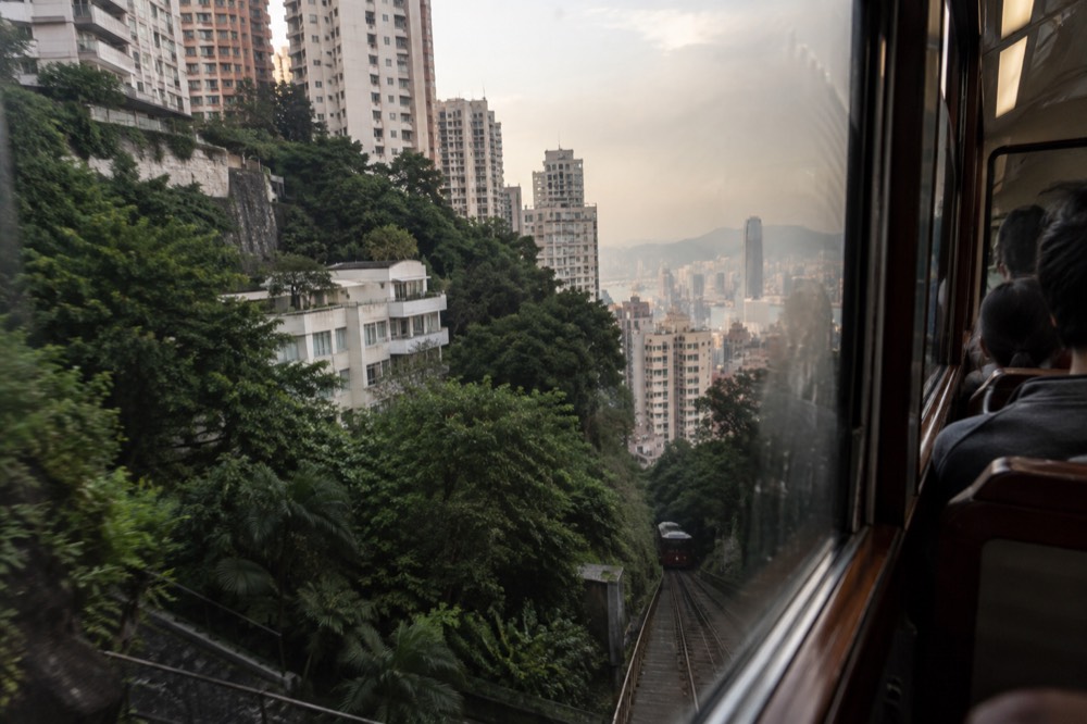 View from the Peak Tram window of Hong Kong apartment towers stacked up the hillside