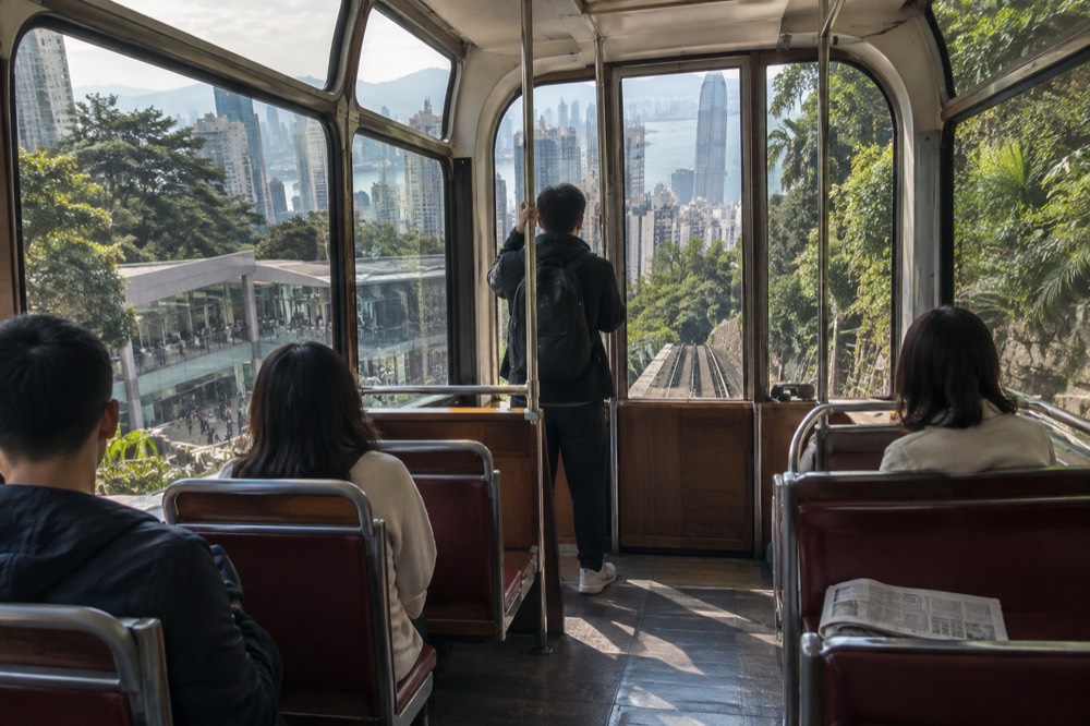 Interior of a modern funicular tramcar with wide panoramic windows and rows of seats