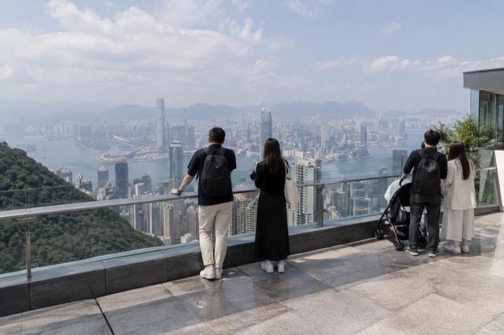 Visitors at the Peak Galleria rooftop deck looking out over Victoria Harbour