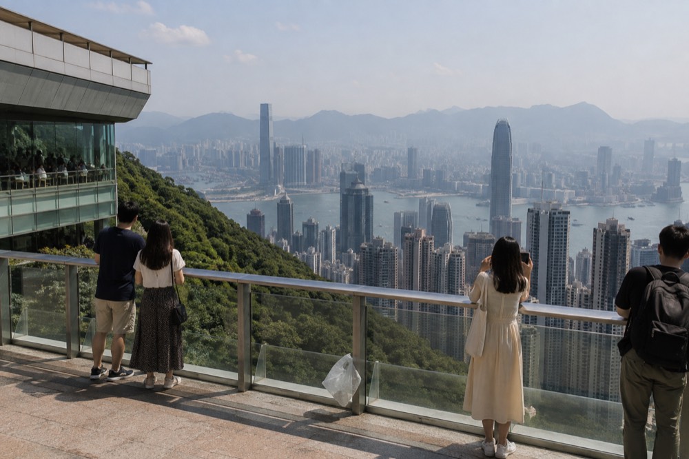 Open rooftop terrace with a railing looking out over dense towers and a harbour