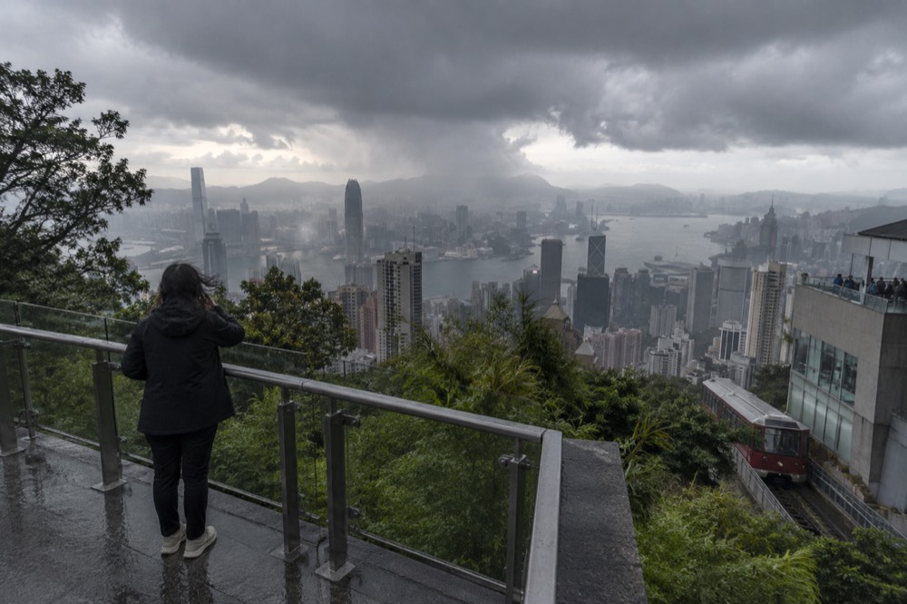 Dark storm clouds gathering over Hong Kong harbour and the hillside below the Peak