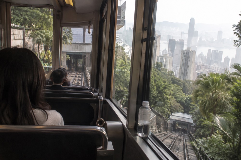 Interior of a modern funicular tramcar with rows of seats and large windows