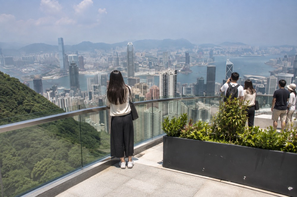 Hong Kong skyline and harbour seen from a hilltop viewing terrace