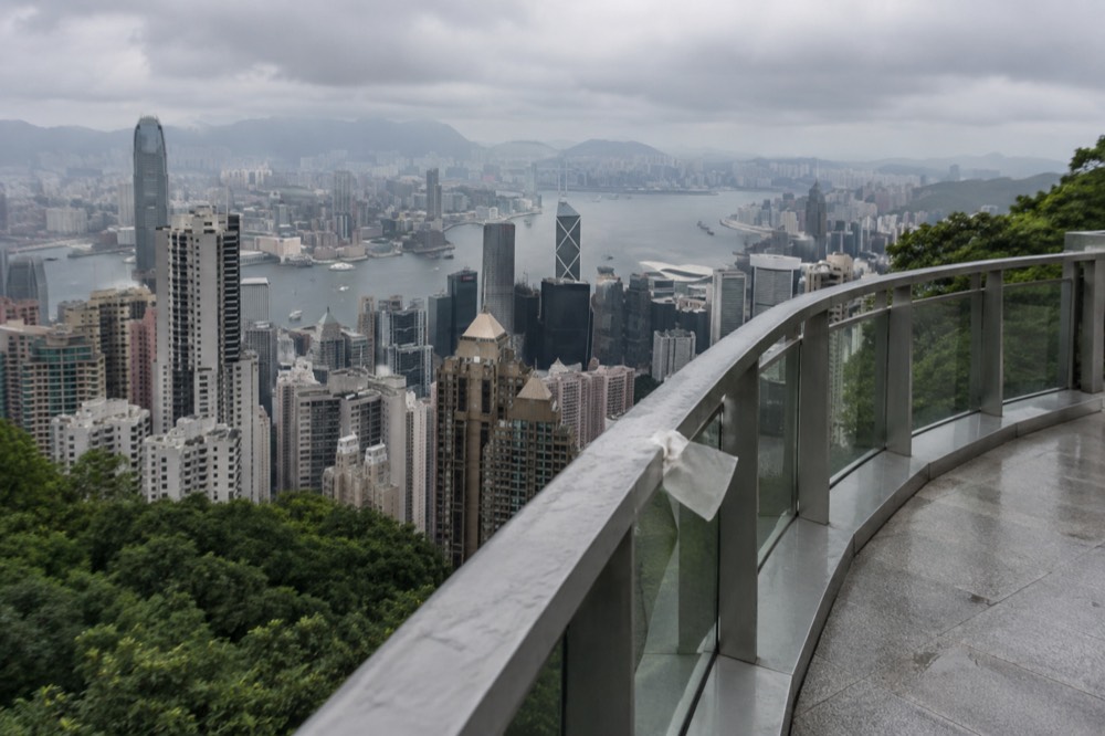 Crowd-free observation deck railing overlooking dense city towers