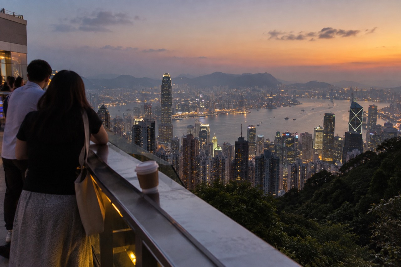 Hong Kong skyline and harbour seen from a hilltop viewing area at dusk