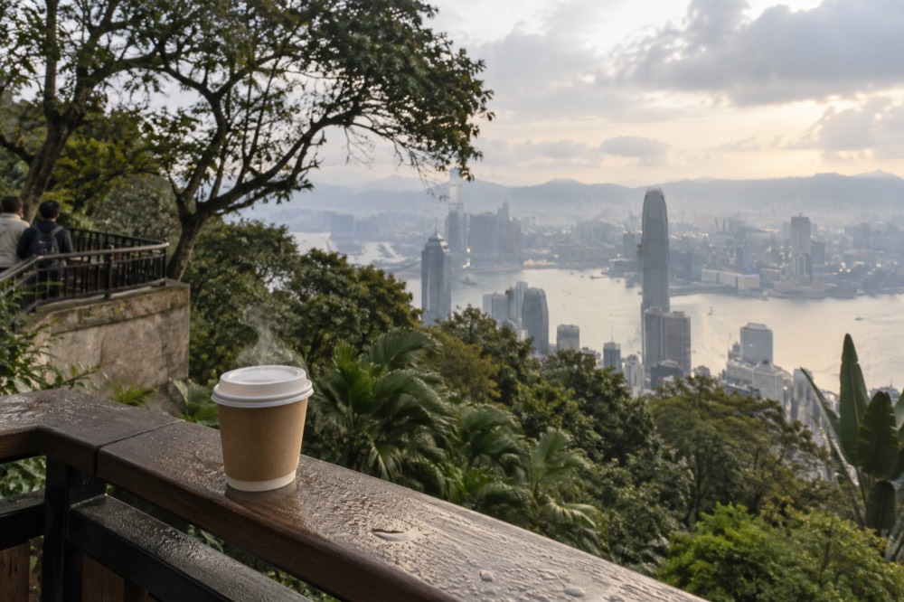 Coffee cup on a railing with the skyline behind